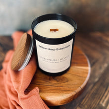 Load image into Gallery viewer, black glass candle jar and white coconut wax with wooden wick from yellow harp essentials in baked plum and honey scent