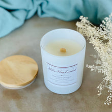Load image into Gallery viewer, highly scented toasted coconut stone fruit coconut wax candle with crackling wood wick in reusable white glass jar and wood lid
