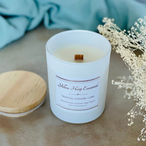 highly scented tropical ginger lime coconut wax candle with crackling wood wick in reusable white glass jar and wood lid