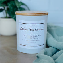Load image into Gallery viewer, highly scented creamy almond milk and spiced tonka coconut wax candle with crackling wood wick in reusable white glass jar and wood lid
