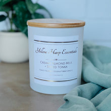 Load image into Gallery viewer, highly scented creamy almond milk and spiced tonka coconut wax candle with crackling wood wick in reusable white glass jar and wood lid
