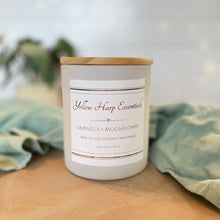 Load image into Gallery viewer, Candle with a label on a wooden surface and green fabric