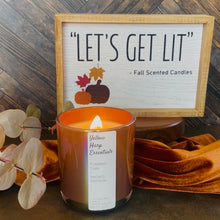 Load image into Gallery viewer, Iridescent terra-cotta clay colored glass jar with white label that says” yellow harp essentials pumpkin chai + smoked saffron coconut wax candle” with eucalyptus leaves and fall decor in the background
