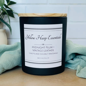 highly scented coconut wax candle with crackling wood wick midnight plum and vintage leather scent black glass reusable jar wooden lid 