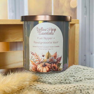 yellow harp essentials coconut wax candle with crackling wood wick in glass jar with metal lid in pink pepper pomegranate scent