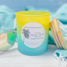 Load image into Gallery viewer, Yellow and blue ombre glass jar with reusable bamboo lid highly scented coconut wax candle with crackling wood wick Basil Lime and mandarin top layer and Seaside Lemon Grove bottom layer
