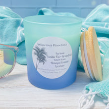 Load image into Gallery viewer, Teal and blue glass jar with reusable bamboo lid highly scented coconut wax candle with crackling wood wick double layered scent vanilla fig and grapefruit top and honeyed coastal lavender bottom
