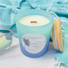 Load image into Gallery viewer, Teal and blue glass jar with reusable bamboo lid highly scented coconut wax candle with crackling wood wick double layered scent vanilla fig and grapefruit top and honeyed coastal lavender bottom
