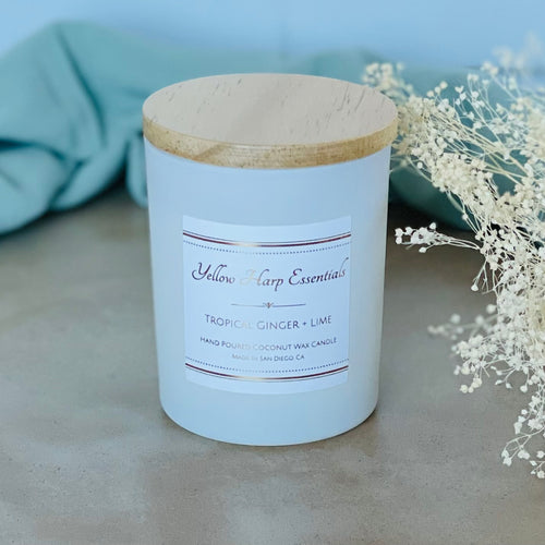 highly scented tropical ginger lime coconut wax candle with crackling wood wick in reusable white glass jar and wood lid