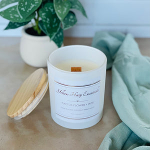 highly scented cactus flower and jade coconut wax candle with crackling wood wick in reusable white glass jar and wood lid