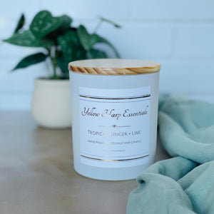 highly scented tropical ginger and lime coconut wax candle with crackling wood wick in reusable white glass jar and wood lid