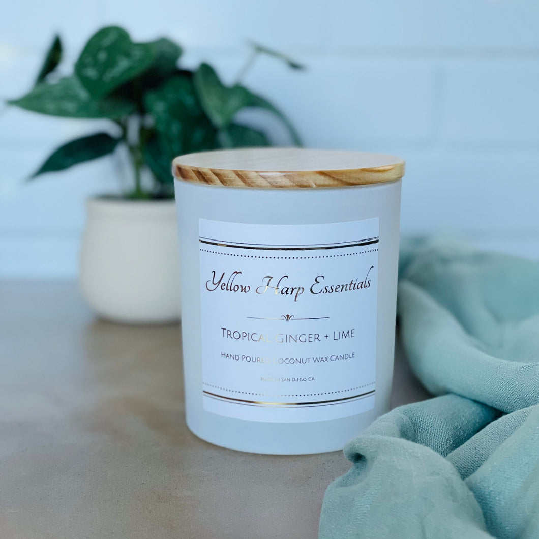 highly scented tropical ginger and lime coconut wax candle with crackling wood wick in reusable white glass jar and wood lid