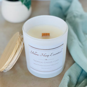 highly scented tropical ginger and lime coconut wax candle with crackling wood wick in reusable white glass jar and wood lid