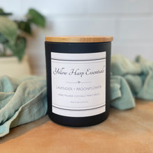 Load image into Gallery viewer, black candle in glass jar with wooden lid on background
