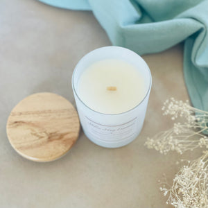 Highly scented hand poured coconut wax candle with crackling wood wick white reusable glass jar wood lid peppermint eucalyptus
