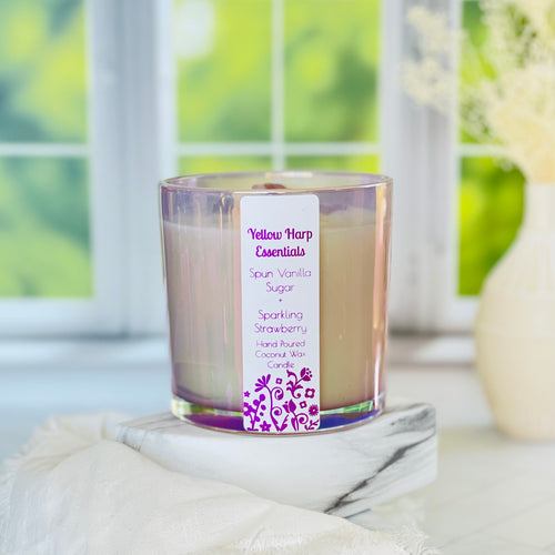 large 14 ounce coconut wax candle with double crackling wood wicks and highly scented spun vanilla sugar sparkling strawberry in reusable glass purple jar and linen bag
