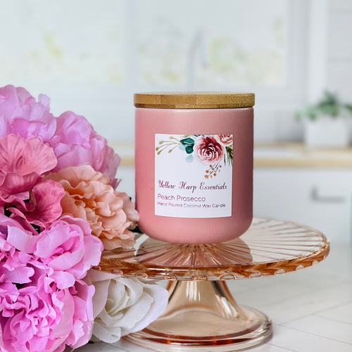 hand poured highly scented coconut wax candle with crackling wood wick peach prosecco scent blush pink ceramic jar bamboo lid